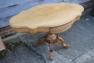 A late 19th century walnut shape top "loo" table, fitted frieze drawer, on turned column and