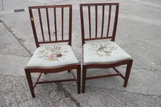 A pair of Georgian provincial mahogany vertical rail back side chairs with serpentine drop-over