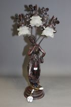 An Art Nouveau style bronzed three-light table lamp, formed as a female figure, with frosted glass