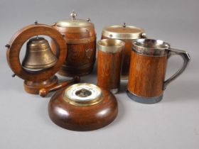 Two coopered oak biscuit barrels and covers, a coopered oak tankard, a beaker, a table bell and an