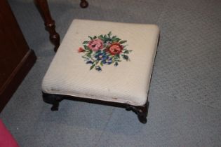 A 19th century oval footstool with needlework top, two smaller circular stools with needlepoint