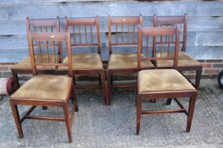 A set of six early 19th century provincial fruitwood and ebony strung vertical rail back dining