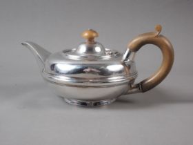 A squat silver teapot with fruitwood knop and handle, 10oz troy approx