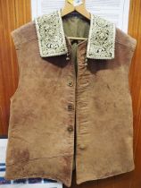 An armourer's leather jerkin and a bishop's gold embroidered collar