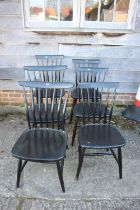 A set of six 1950s Akerblom ebonised shaped vertical rail back dining chairs, designed by Bongt