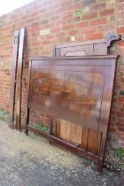 A 1920s carved mahogany panel end bed frame with figured side rails, 62" wide overall