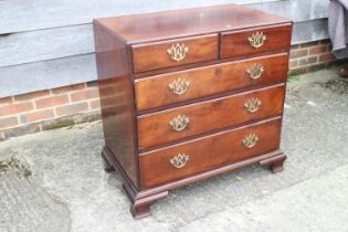 A Georgian mahogany chest of two short and three long graduated drawers, with pierced brass