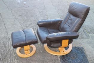 An Ekorness black leather recliner "Stressless" type armchair and a companion footstool