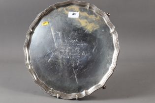 A silver salver with beaded border, raised on four ball and claw supports, 35.8oz troy approx