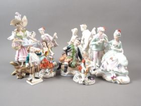Four Continental porcelain figure groups, in period costumes, and four similar figures, tallest 8"