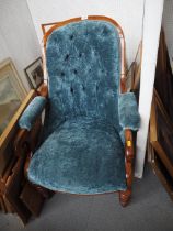 A mid 19th century rosewood showframe open armchair, button upholstered in a blue crushed velvet, on