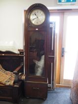 An early 20th century oak cased arch topped long case clock with silvered dial and Arabic