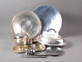 A silver plated entree dish and cover, a plated circular gallery tray, six other trays/salvers and