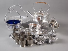 A silver plated kettle on stand, a plated swing handle basket, a plated sugar chute, a pair of