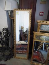 A gilded slip mirror with bevelled plate,14 3/4" x 48 3/4" overall