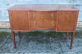 An Edwardian mahogany break bowfront sideboard, fitted two central drawers flanked cupboards, on