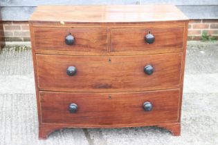 A 19th century mahogany and box strung bowfront chest of two short and two long drawers with knob
