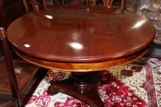 A hardwood circular topped centre table, on bulbous turned column and tri-form base, 43" dia