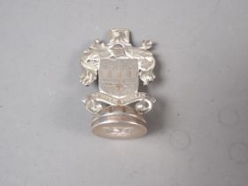A white metal desk seal with "Semper Fidelis" armorial and engraved matrix