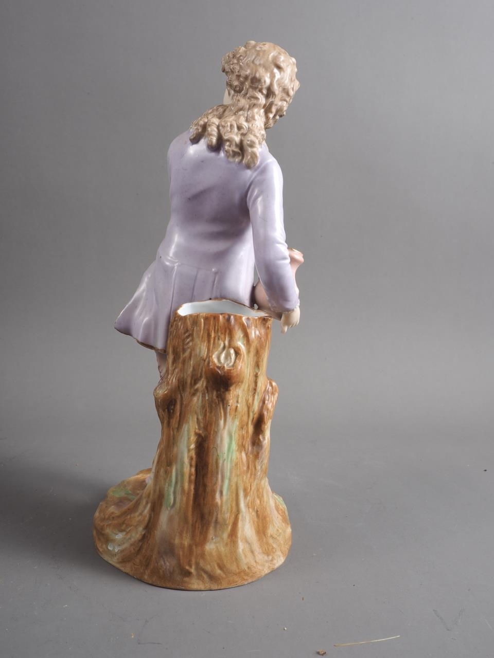 A German porcelain figure/spill vase, formed as a young man holding a jug, 11" high - Image 2 of 3