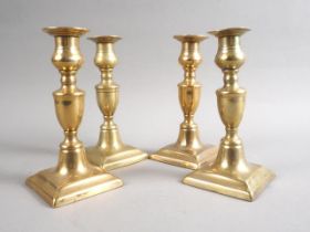 A set of four 19th century brass square base candlesticks, 6 1/2" high