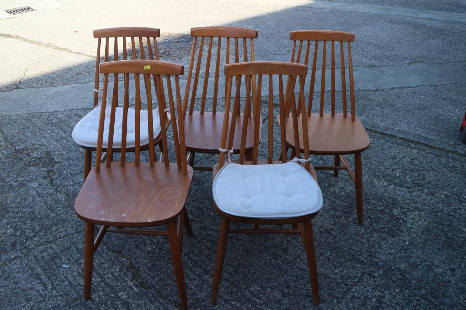 A set of five 1970s beech spindle back dining chairs with panel seats