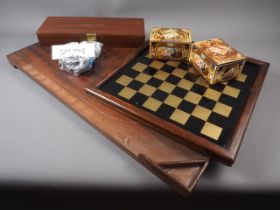 A shove ha'penny board, a collection of 1/2d and other coins, a chess board, two sets of dominoes,