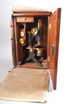 A 19th century brass microscope, in mahogany case