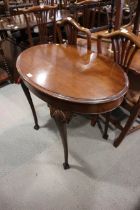 A mahogany oval side table, on shell decorated cabriole supports with ball and claw feet, 36" wide x