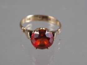 A 9ct gold and synthetic sapphire single stone cocktail ring, size M/N, 2.8g