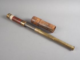 An officer's early 19th century brass and mahogany three-draw telescope, in leather case, said to