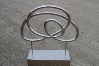 A cast aluminium "Pretzel" sculpture on rectangular base, 30" high