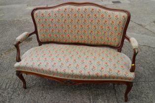 A late 19th century carved walnut and brass mounted two-seat showframe settee of Louis XVI design,