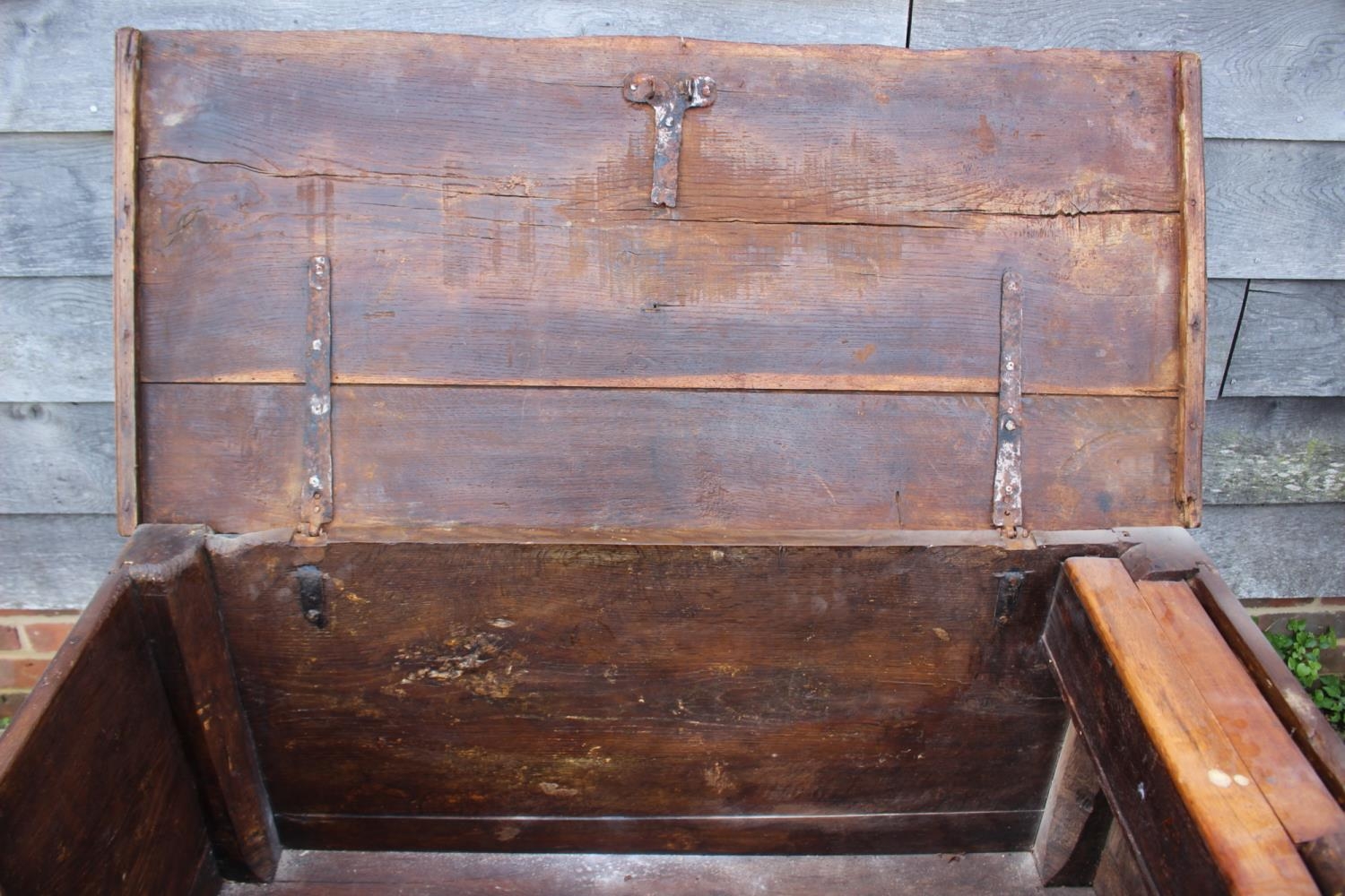 An early 18th century Hanseatic planked oak coffer, the interior fitted candle box, on stile - Image 2 of 5