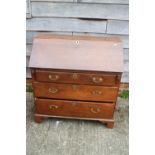 An early 20th century oak fall front bureau, the interior fitted cupboard, drawers and pigeon holes,