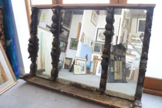 An early 20th century overmantel mirror with four carved animal uprights, 72" x 44"