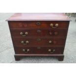 A George III mahogany chest of four long graduated drawers with gilt brass bail handles, on