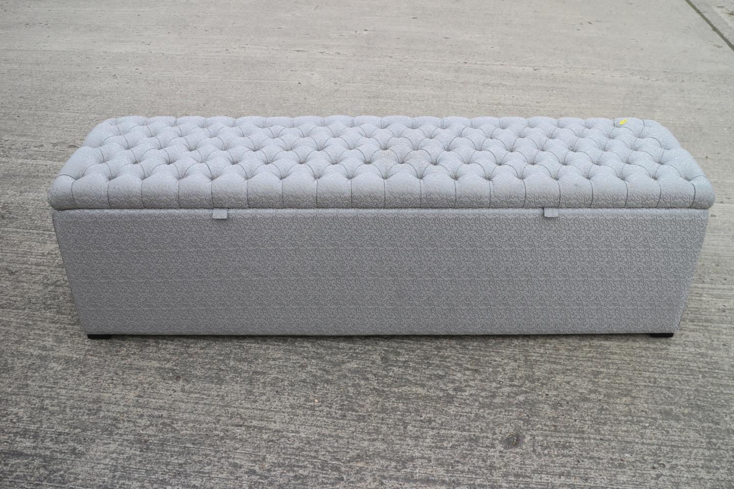 A box ottoman, upholstered in a wriggle pattern fabric, 64" wide