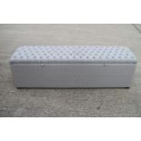 A box ottoman, upholstered in a wriggle pattern fabric, 64" wide