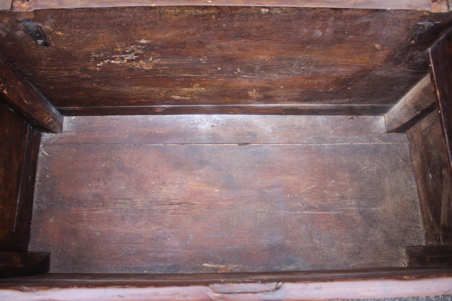 An early 18th century Hanseatic planked oak coffer, the interior fitted candle box, on stile - Image 4 of 5