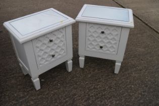A pair of mirror topped bedside chests of two drawers, 19" wide x 13 1/2" deep x 23 1/2" high