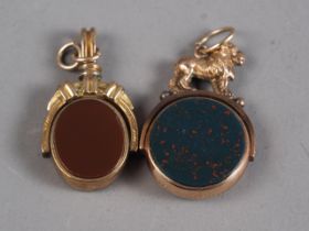 A 9ct gold, bloodstone and carnelian fob spinner with lion surmount and another similar