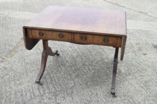 A 19th century mahogany and line inlaid sofa table, fitted two drawers with brass ring handles, on