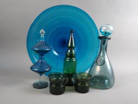 A pair of Dansk design green glass candlesticks, three 1960s art glass decanters and stoppers, and