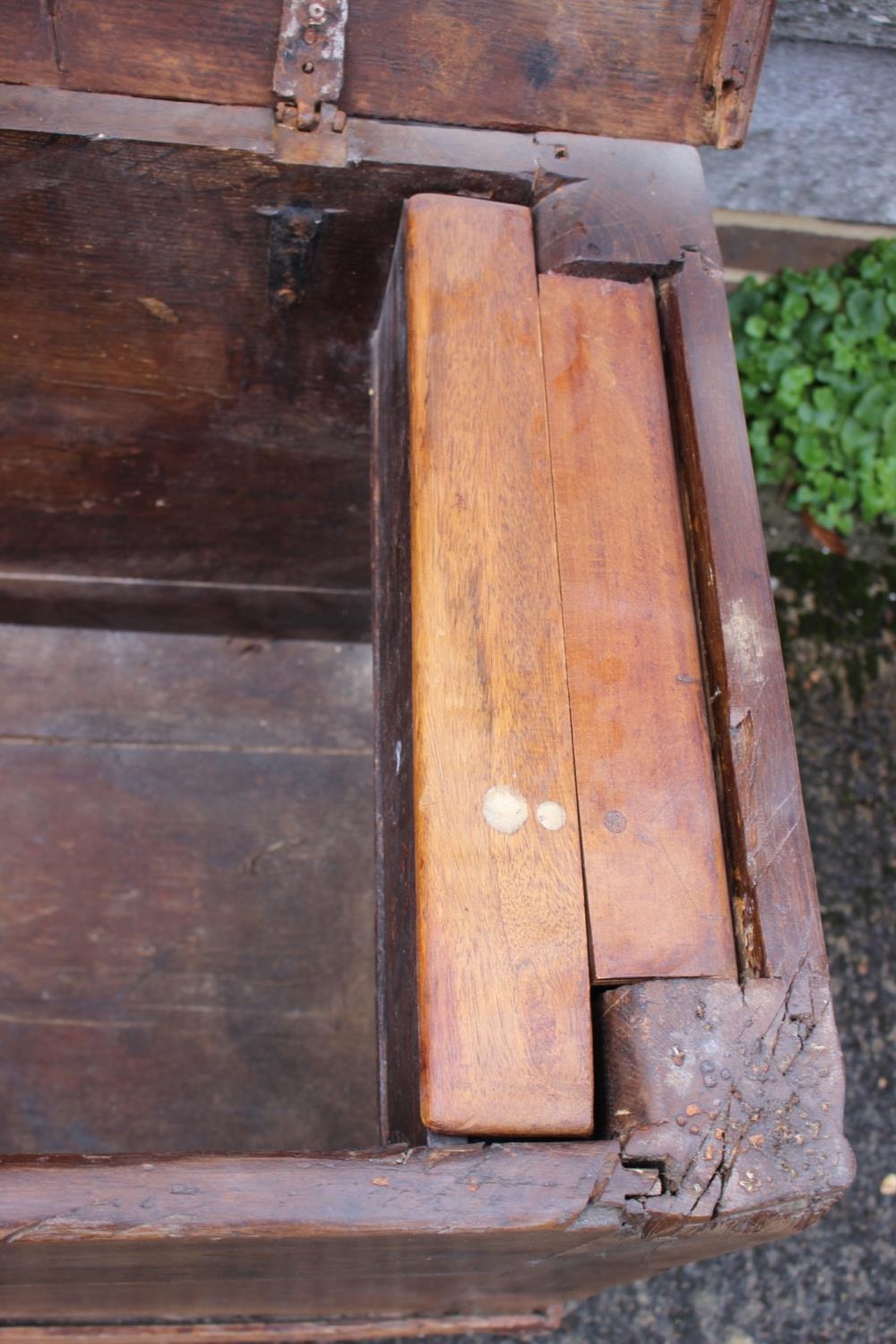 An early 18th century Hanseatic planked oak coffer, the interior fitted candle box, on stile - Image 3 of 5