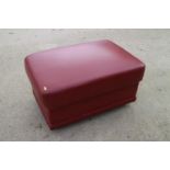 A rust leather ottoman, on chrome support, 31" wide x 21" deep x 17" high