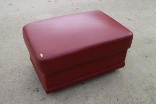 A rust leather ottoman, on chrome support, 31" wide x 21" deep x 17" high