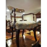 A Regency mahogany and brass inlaid bar back carver dining chair with stuffed over seat, on sabre