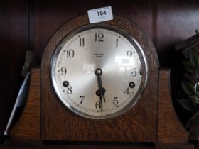 A 1950s oak cased mantel clock by Kirner Bros Oxford with eight-day striking and chiming movement,