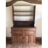 An early 20th century oak bookcase with open shelves over cupboards, on block base, 50" wide x 23"